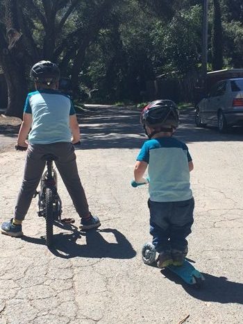 Young boys scooting though isolated in a season of hard