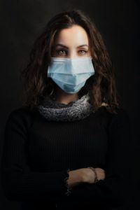 A stylish woman in a medical mask