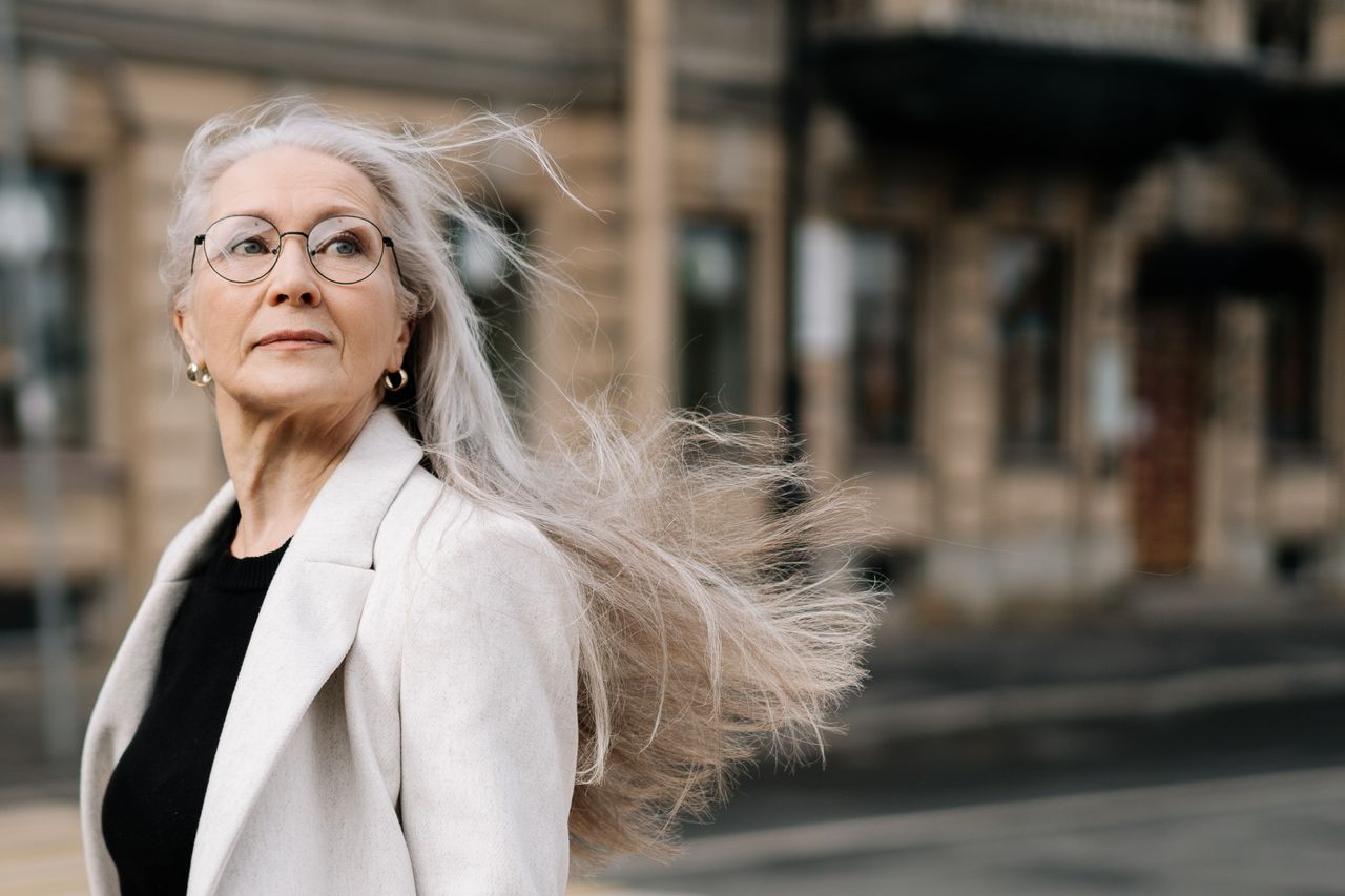 An elegant woman with long gray hair